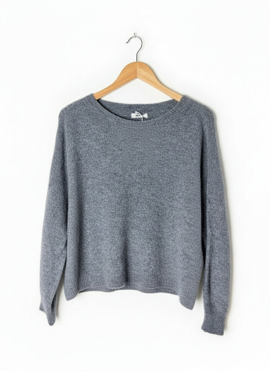 Gray sweater on a wooden hanger against a white background