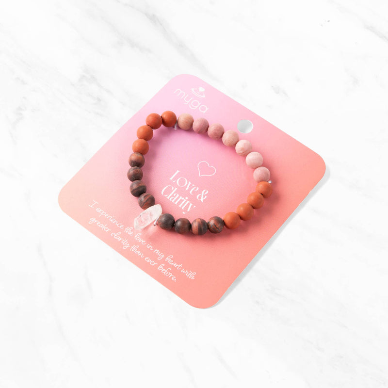 Beaded bracelet on a pink card with 'Love & Clarity' text on a white background
