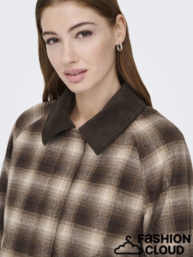 Woman wearing a brown and beige checkered shirt with a collar on a white background, branded Only