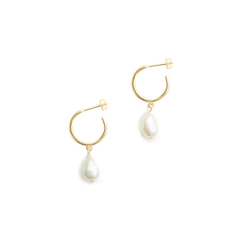 Gold hoop earrings with pearl drops on a white background