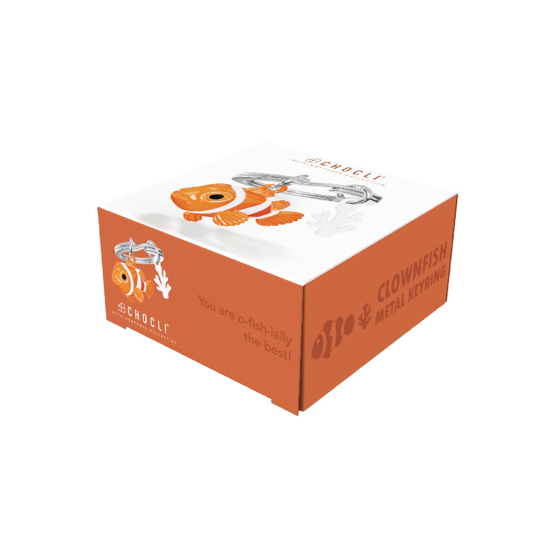 An orange and white branded product box for clownfish metal keychains, featuring an illustration of a clownfish and the text 'CLOWNFISH METAL KEYRING' on a clean white background.