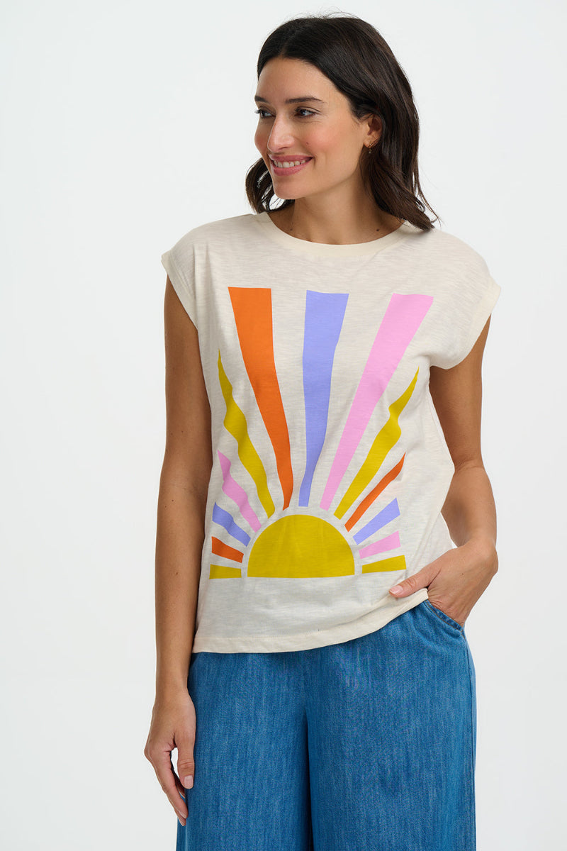 Woman wearing a sleeveless top with a colorful sun design on a white background