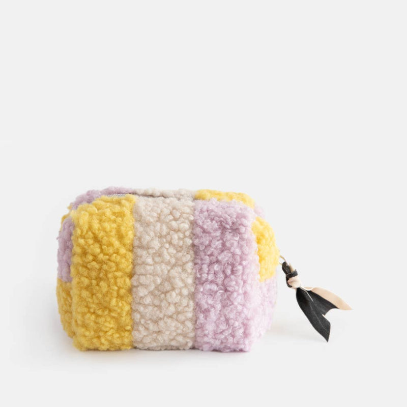 Multicolored striped pouch with a black strap on a white background