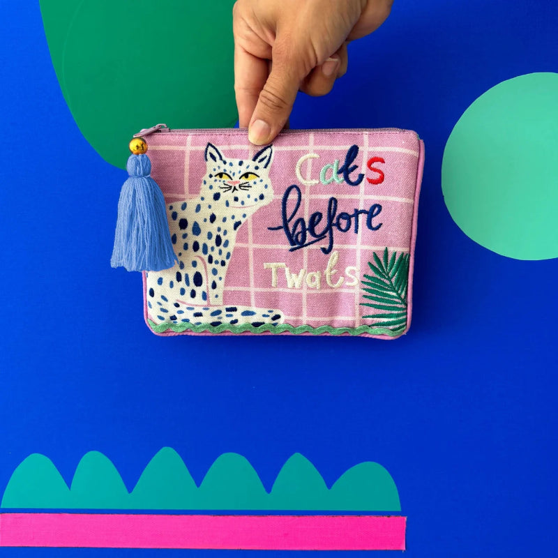 Pink pouch with a cat illustration and text on a blue background