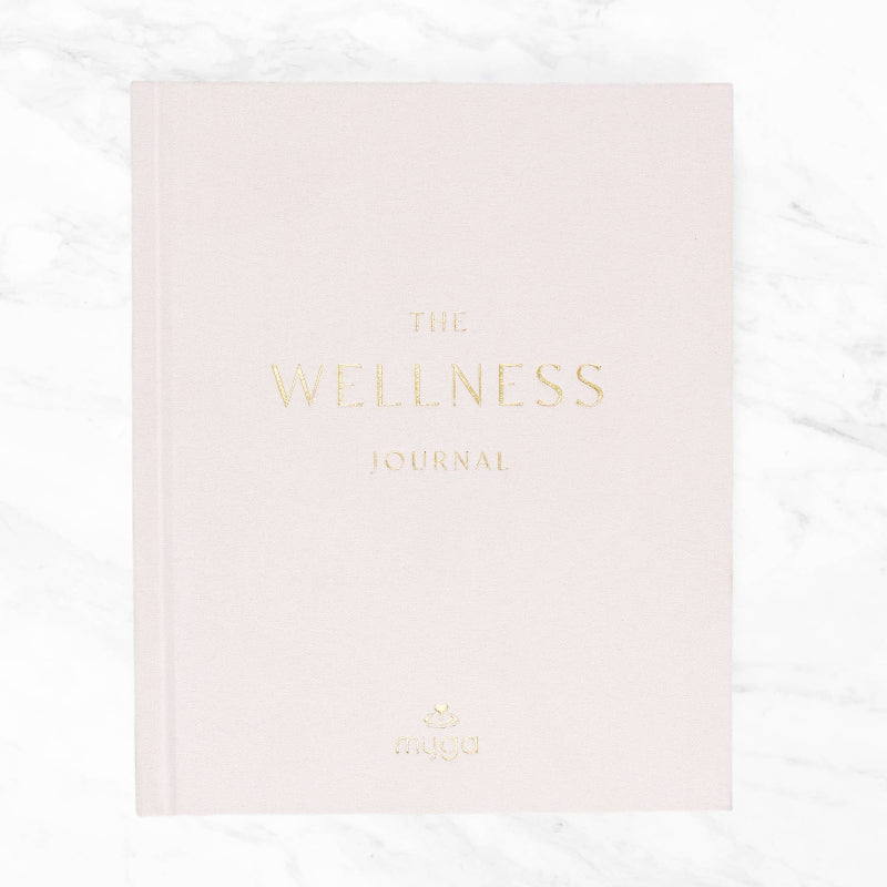 Pink journal titled 'The Wellness Journal' on a white background