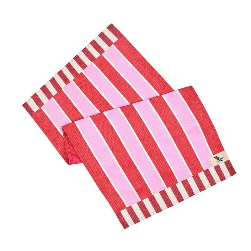 Red and pink striped towel with a small tag on a white background