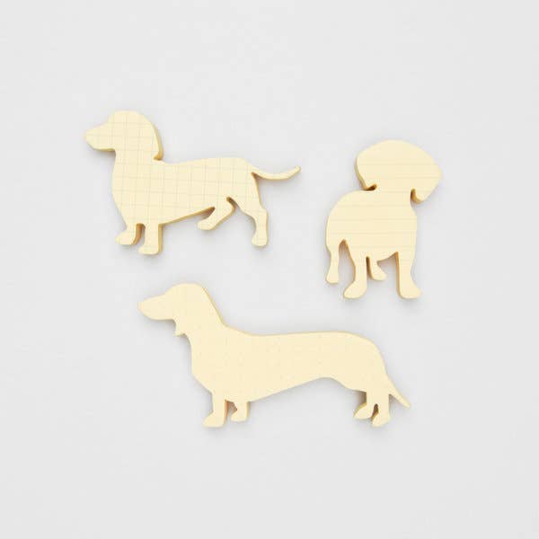 Three wooden dog silhouette cutouts on a white background