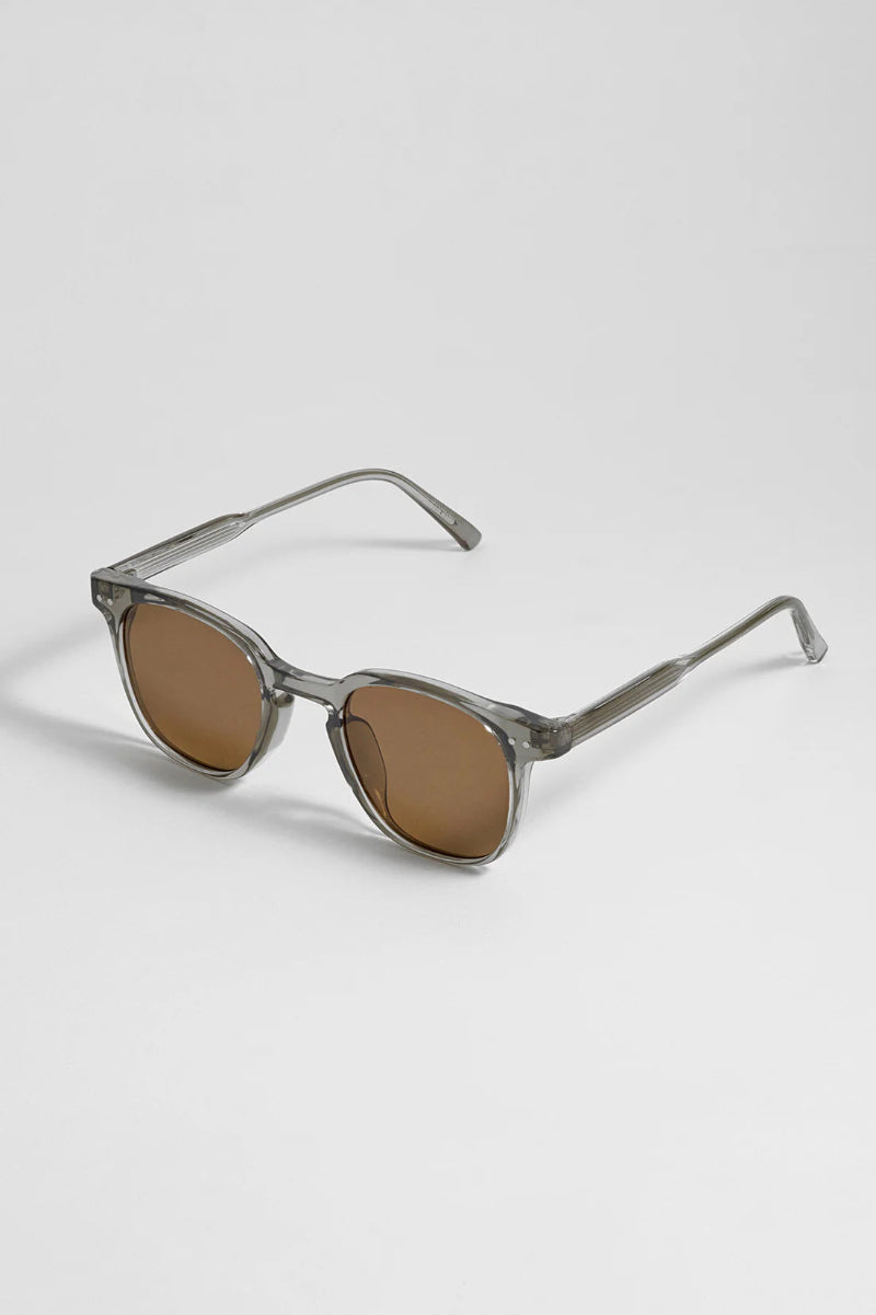 Sunglasses with brown lenses and gray frames on a white background