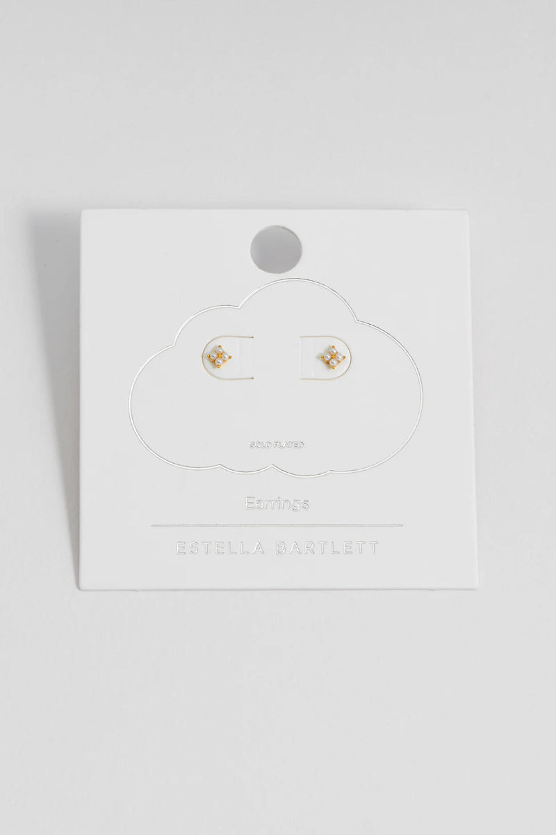 Pair of gold earrings on a white card with 'Estella Bartlett' branding against a light gray background.