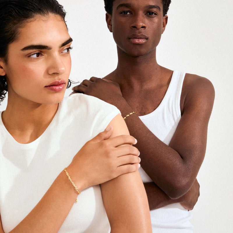 Two people wearing white tops against a plain background