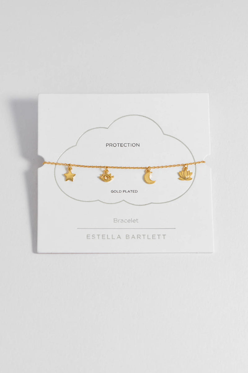 Gold-plated bracelet with star, moon, and anchor charms on a white card with 'Estella Bartlett' branding.