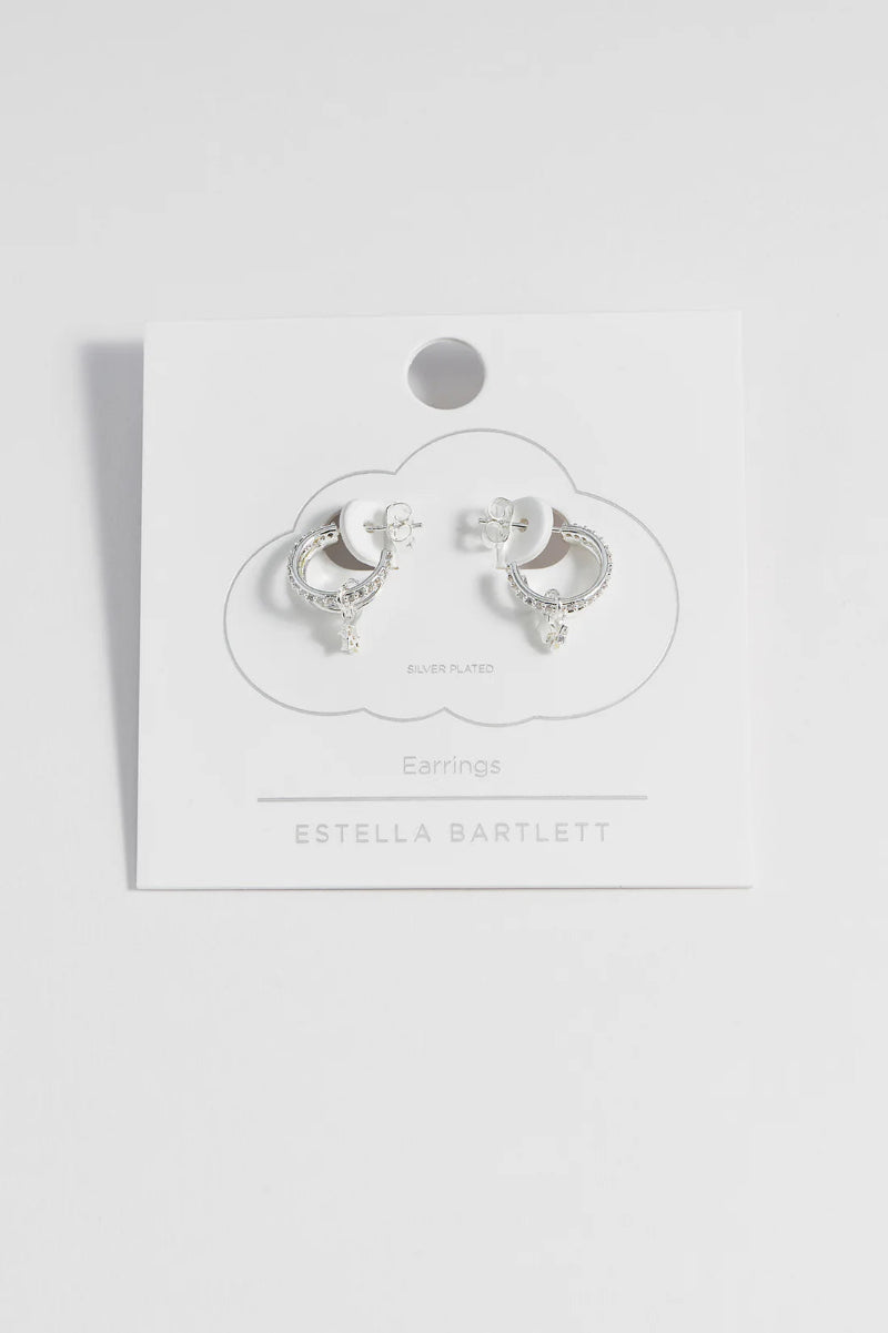 Pair of silver earrings on a branded card with 'Estella Bartlett' branding.