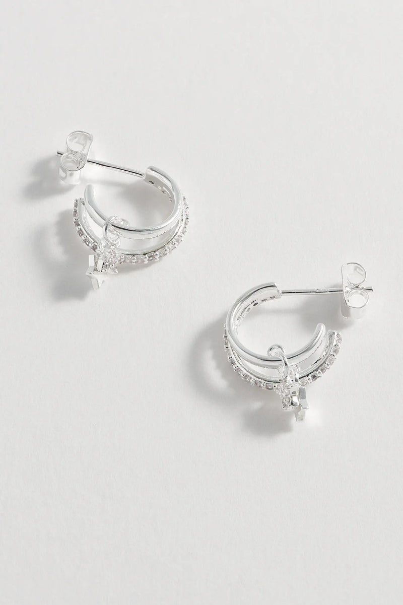 Silver hoop earrings with clear stones on a light gray background