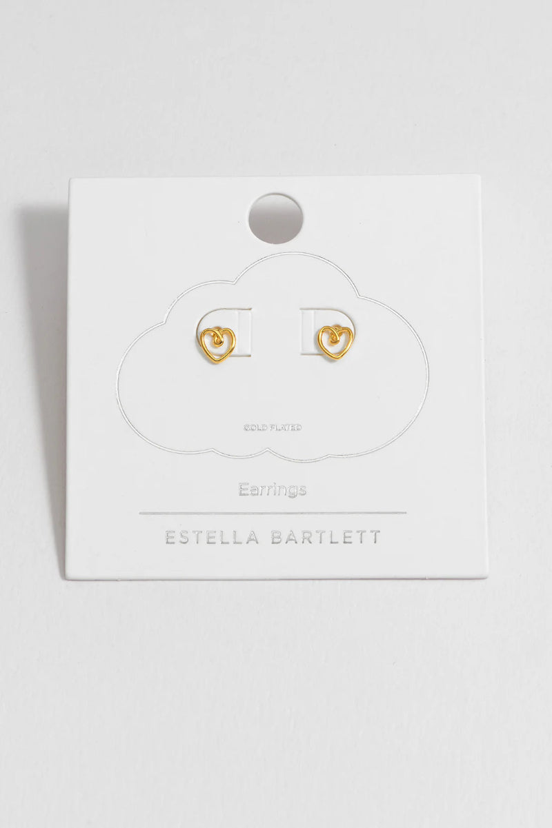 Gold heart-shaped earrings in a 'Estella Bartlett' branded box on a white background