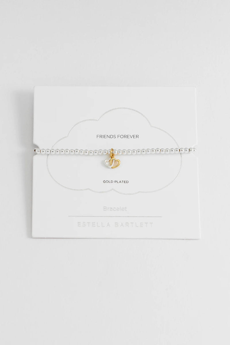 Gold pendant on a white card with 'Friends Forever' text on a light gray background