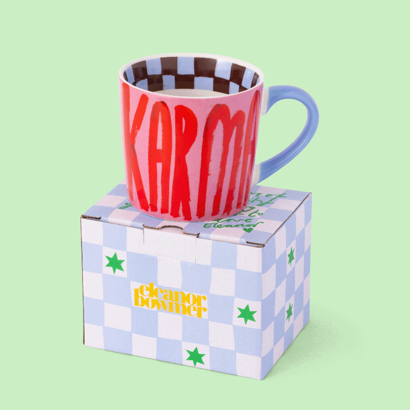 Colourful Eleanor Bowmer Good Karma Mug text on a checkered box against a light green background
