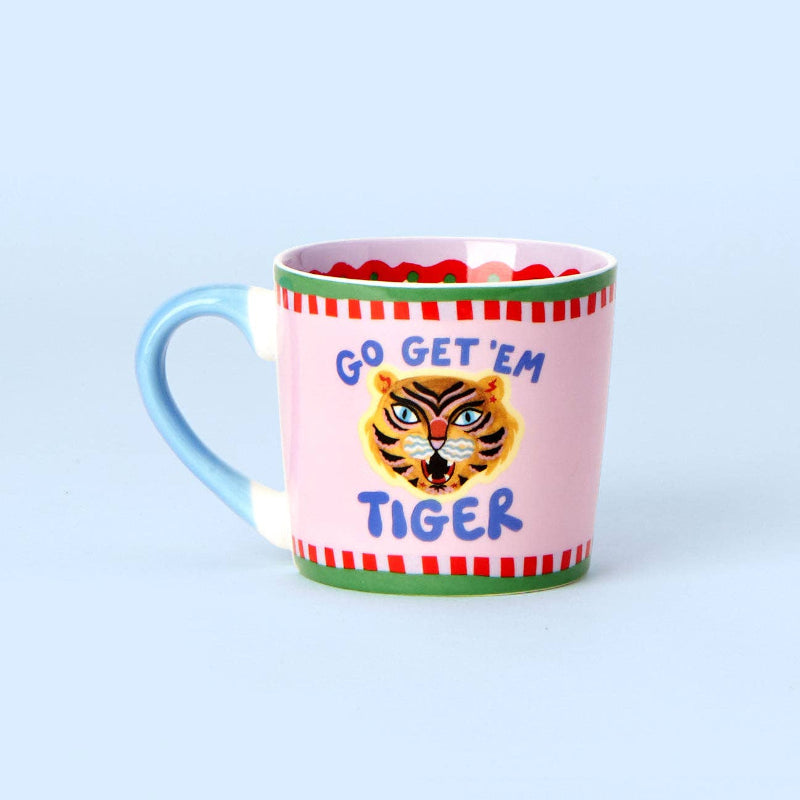 Pink mug with tiger design and 'Go Get 'Em Tiger' text on a light blue background
