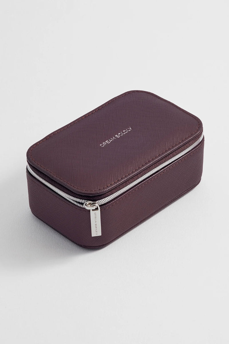 Brown jewelry box with a silver zipper on a light gray background