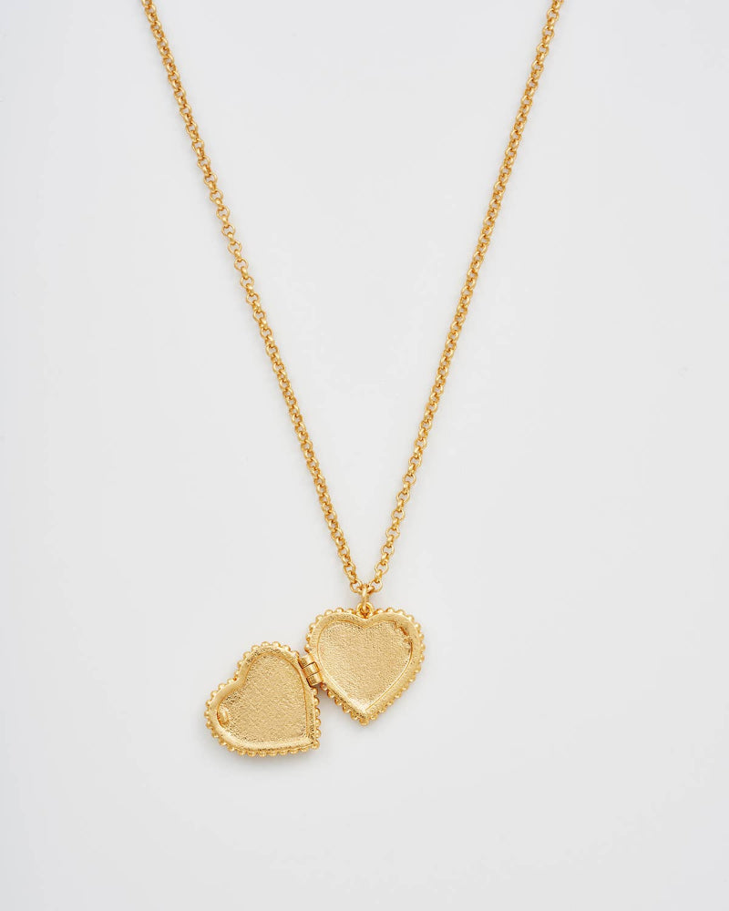Gold heart-shaped locket necklace on a light gray background