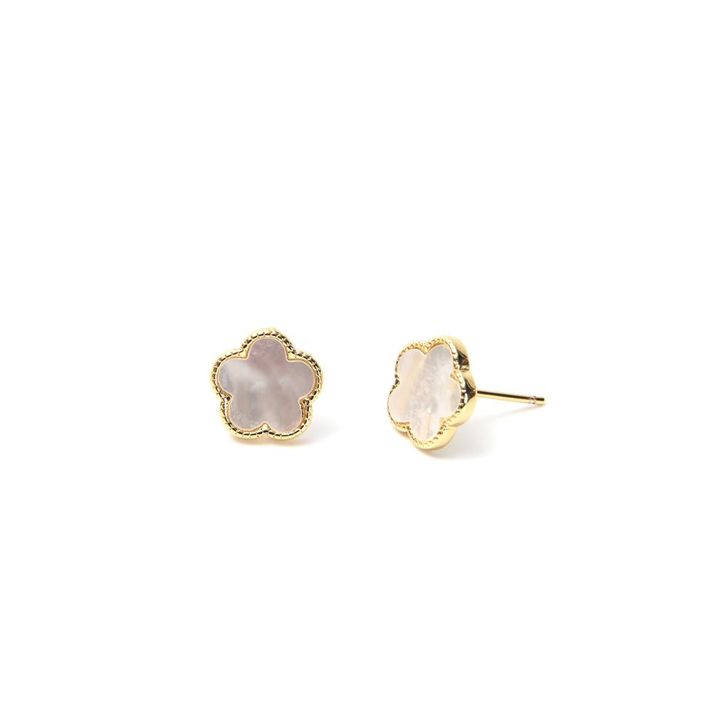 Pair of gold earrings with pink stone centers on a white background