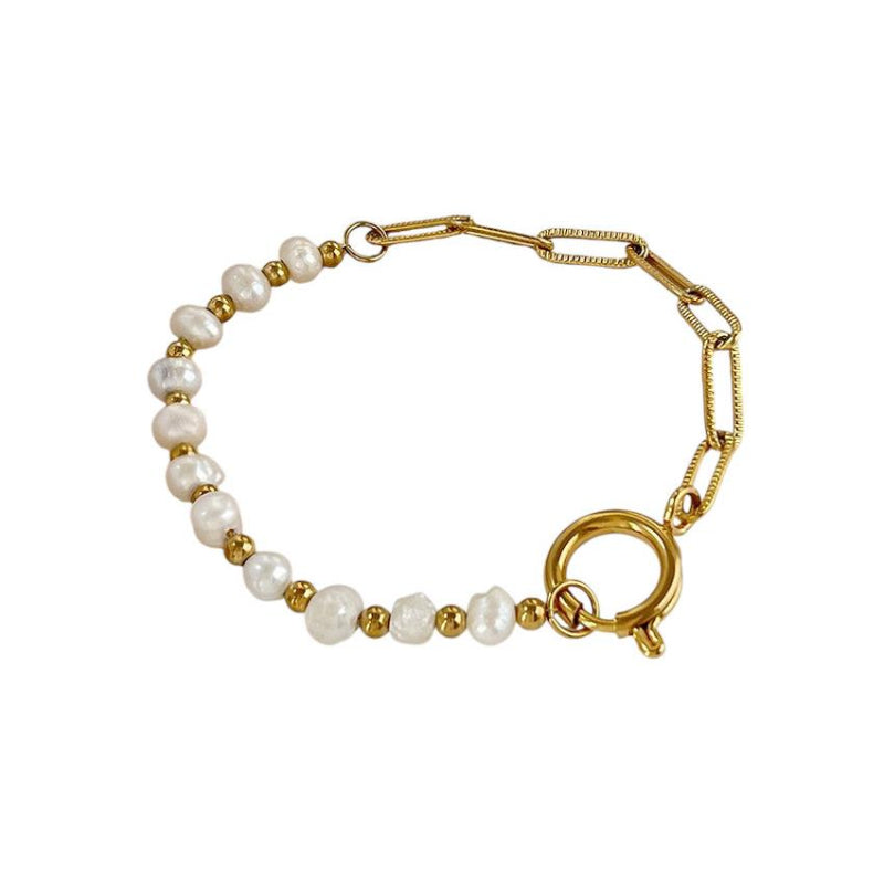 Gold bracelet with pearl beads on a white background