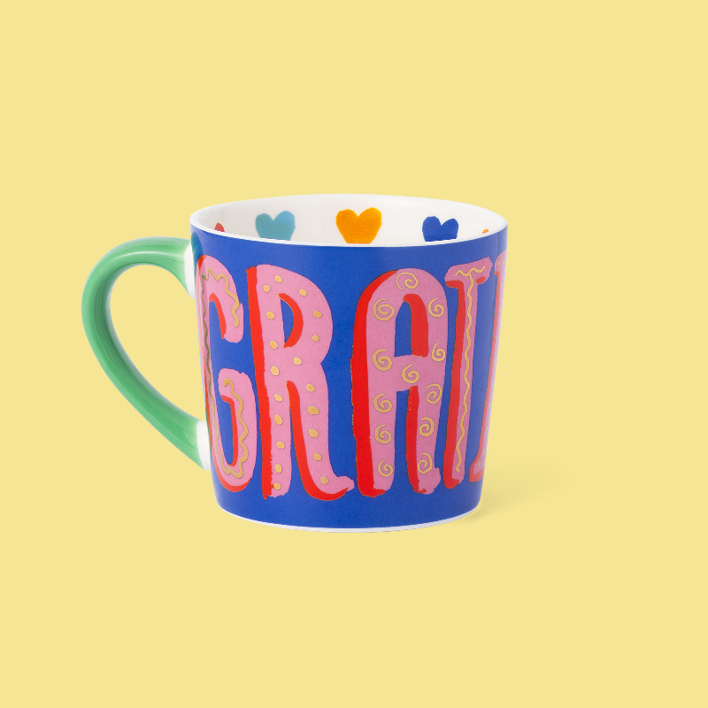 Colourful mug with 'GRATITUDE' text on a yellow background
