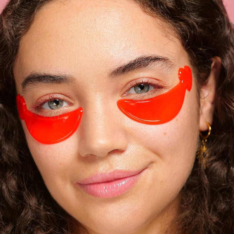 Close-up of a person wearing red eye masks with a blurred background