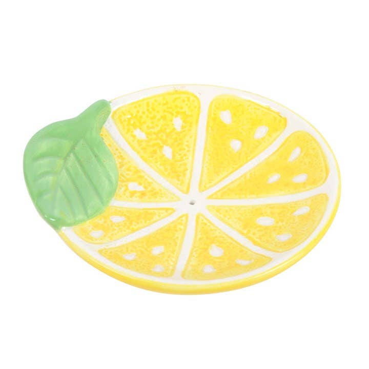 Lemon-shaped ceramic plate with a green leaf on a white background