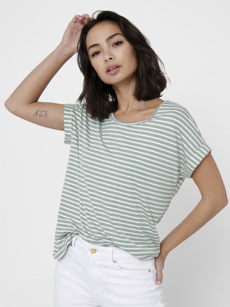 Woman wearing a green and white striped t-shirt against a plain background