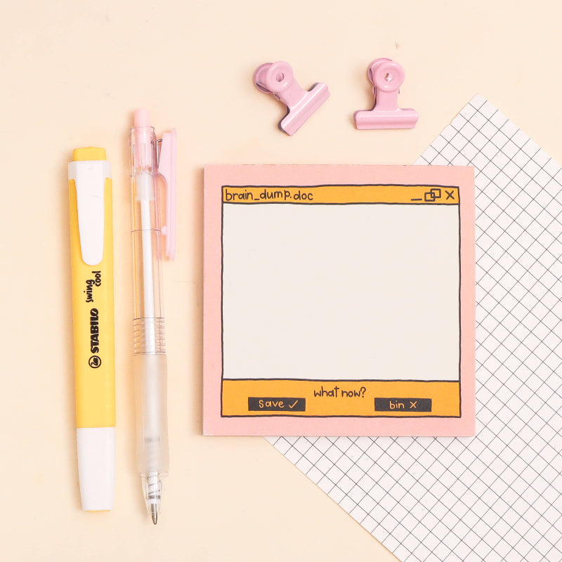 memo pad with digital interface design, pens, and clips on a light background