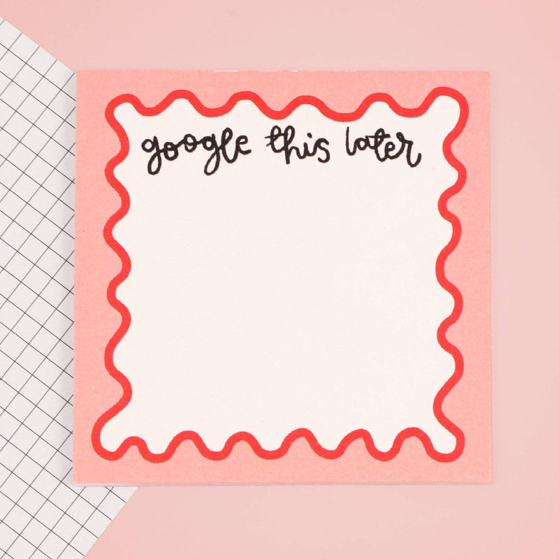Notepad with 'google this later' text on a pink background