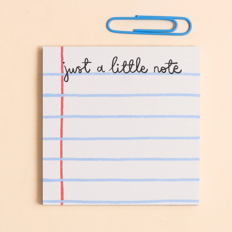 memo pa with 'just a little note' text and blue paper clip on beige background