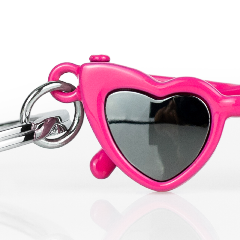 Pink heart-shaped sunglasses keychain on a white background