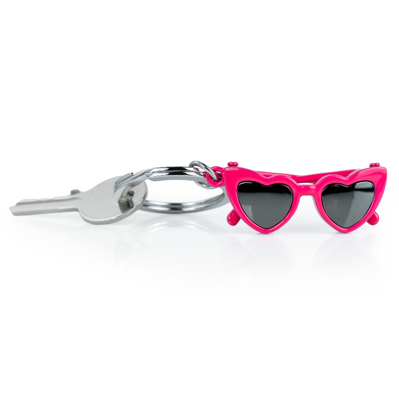 Pink heart-shaped sunglasses keychain on a white background