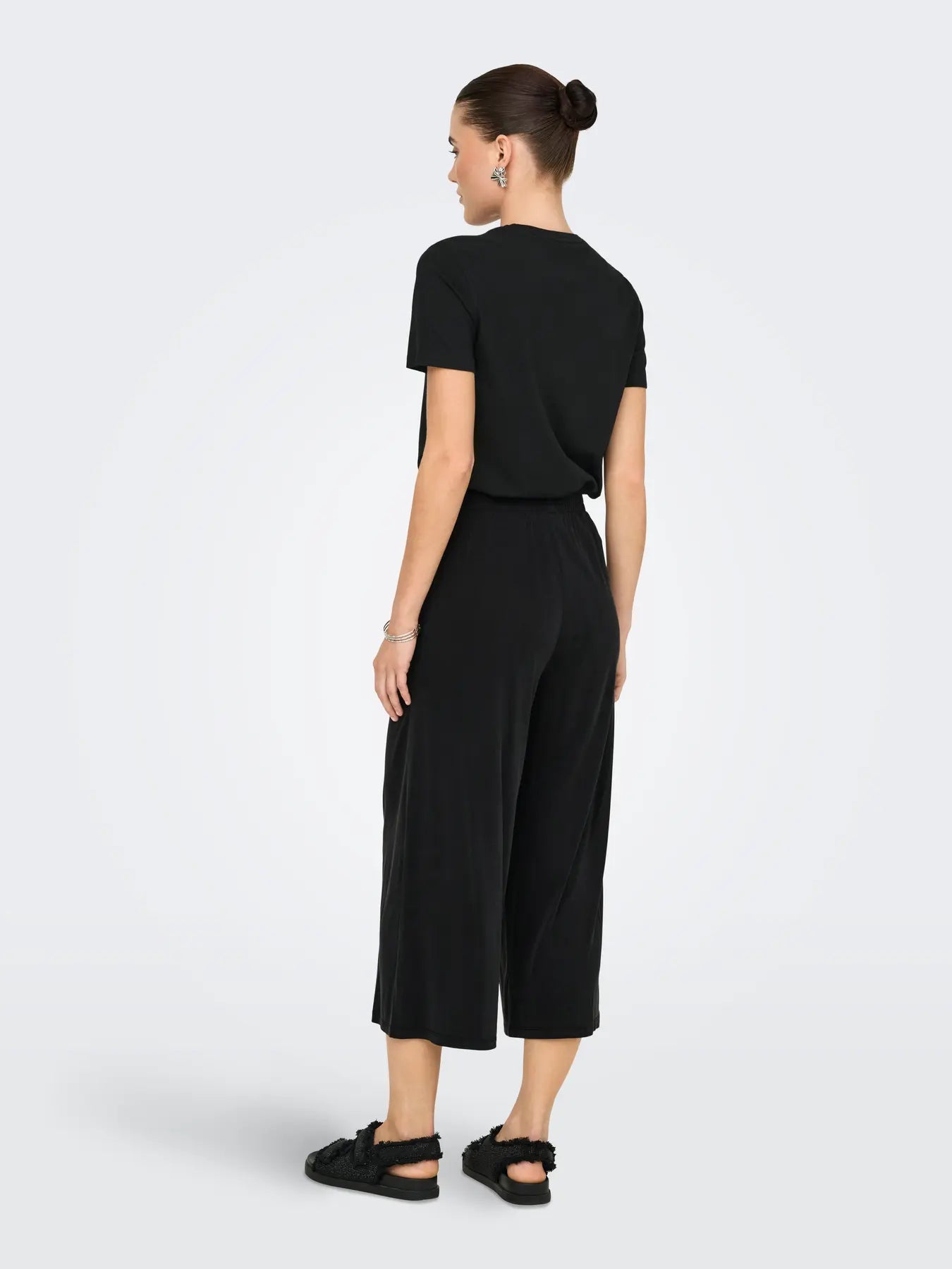 Woman wearing a black outfit on a white background