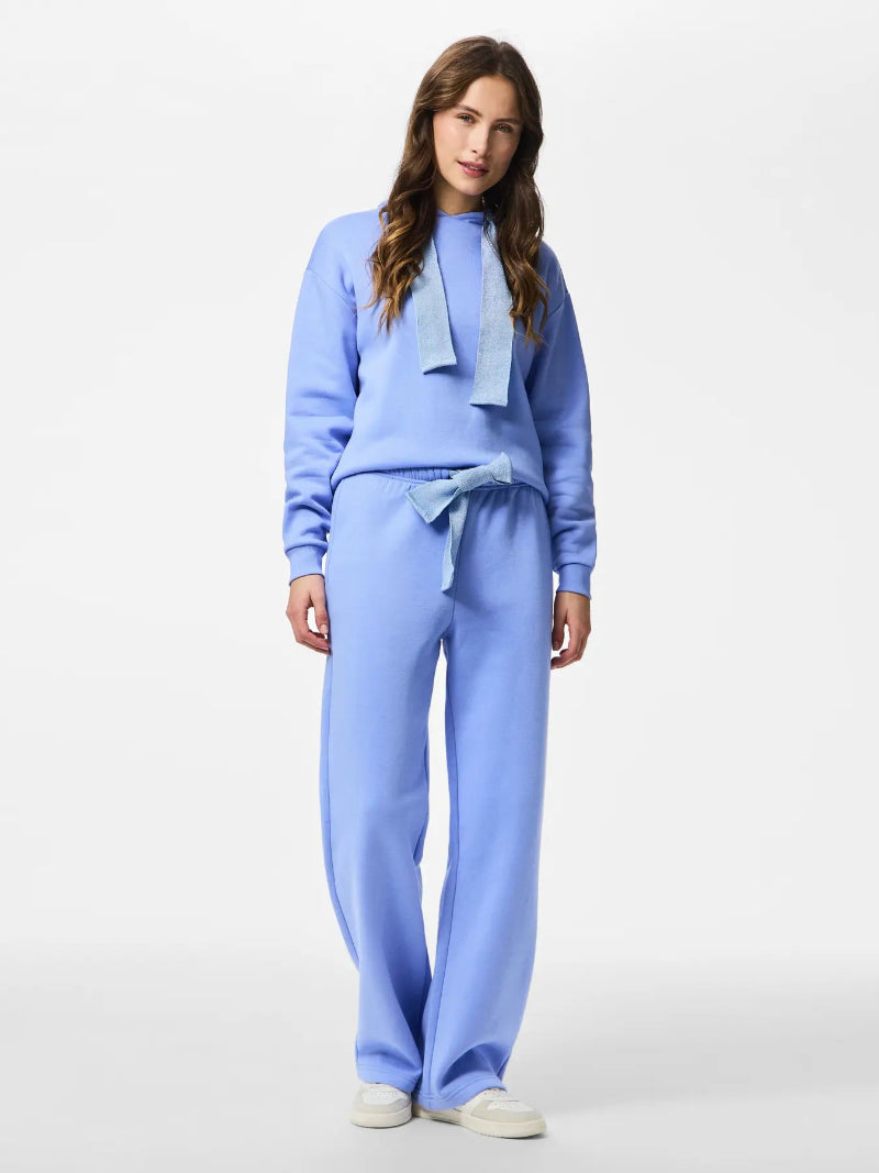 Woman wearing Pieces Chilli Glitter Hoodie Hydrangea Blue outfit on a white background