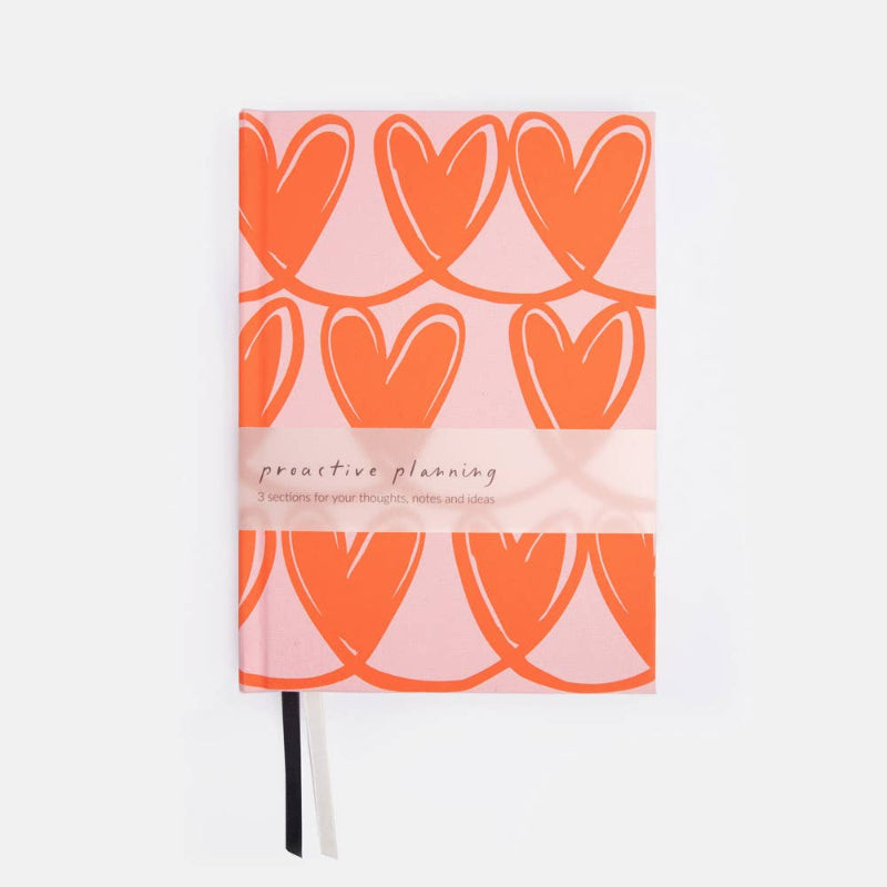 Notebook with orange heart pattern on a white background