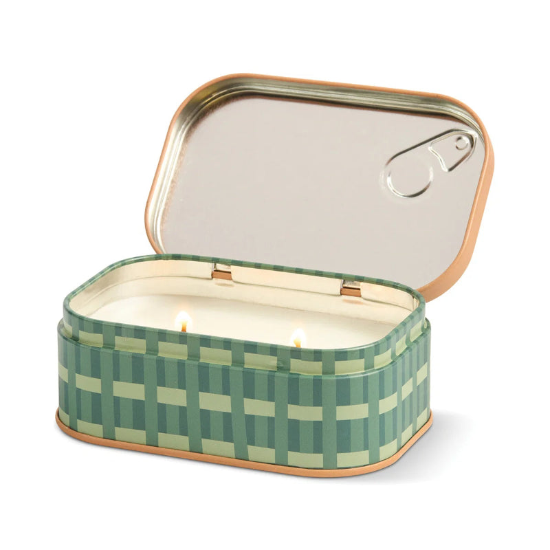 Green checkered candle in a tin with a white background