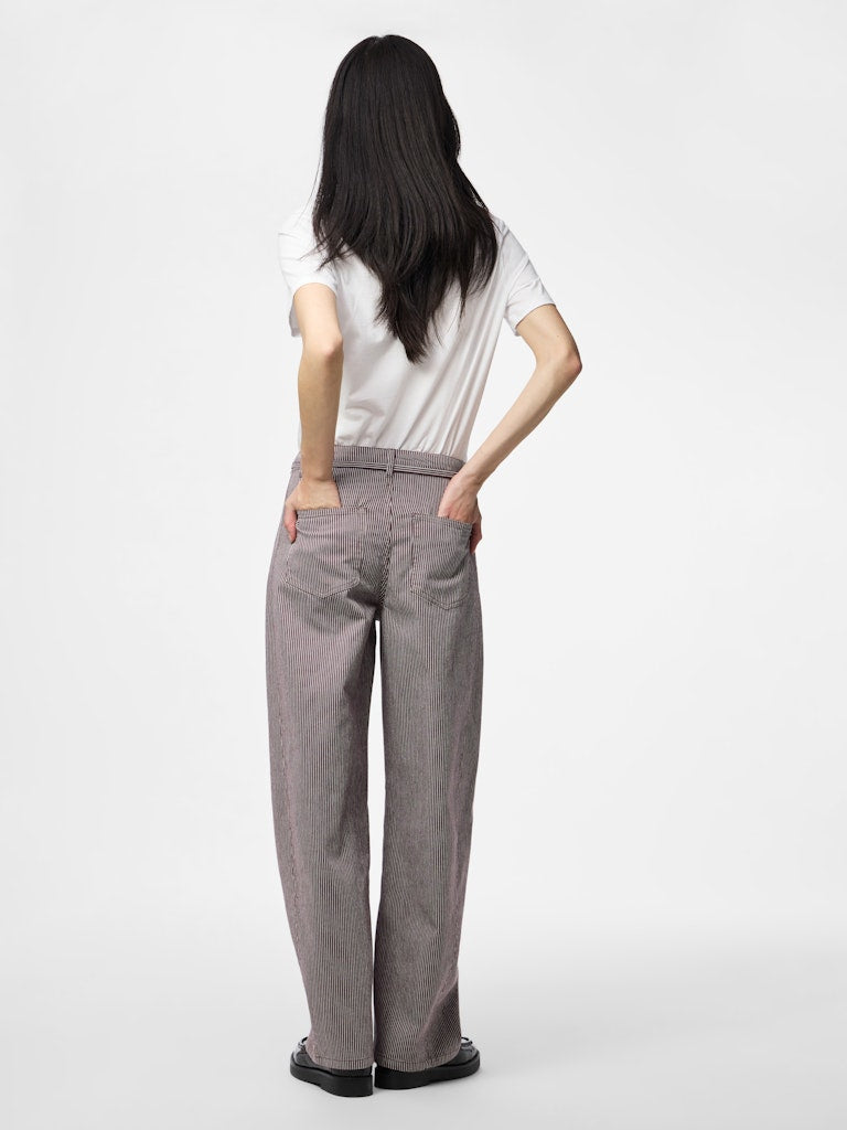 Person wearing gray pants and a white top on a white background