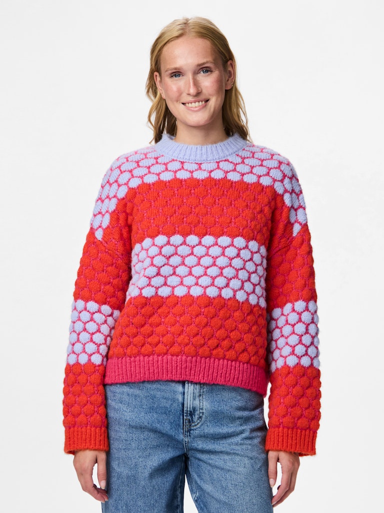 Person wearing Pieces Janel Knit Jumper a red and pink patterned sweater on a white background
