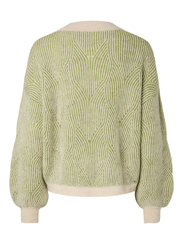 A light green and cream cable-knit sweater shown from the back, featuring a textured geometric pattern and ribbed collar, hem, and cuffs.