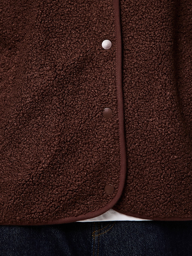 Close-up of a brown textured fabric with buttons