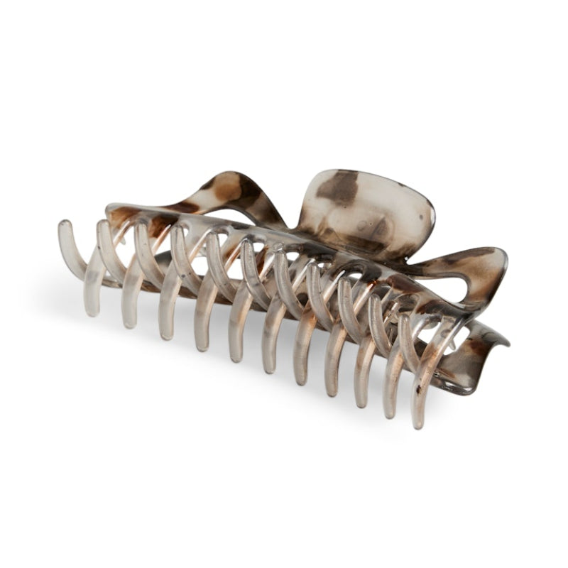 Metallic hair clamp with tortoiseshell accents on a white background