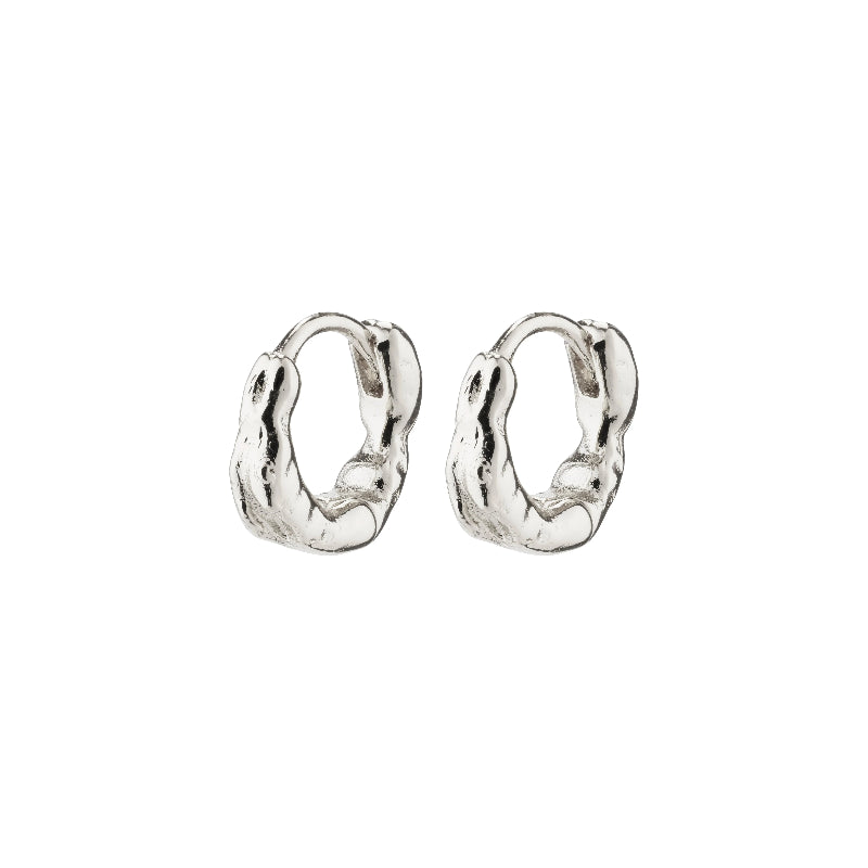 A pair of textured, organic-shaped silver huggie hoop earrings on a plain white background.