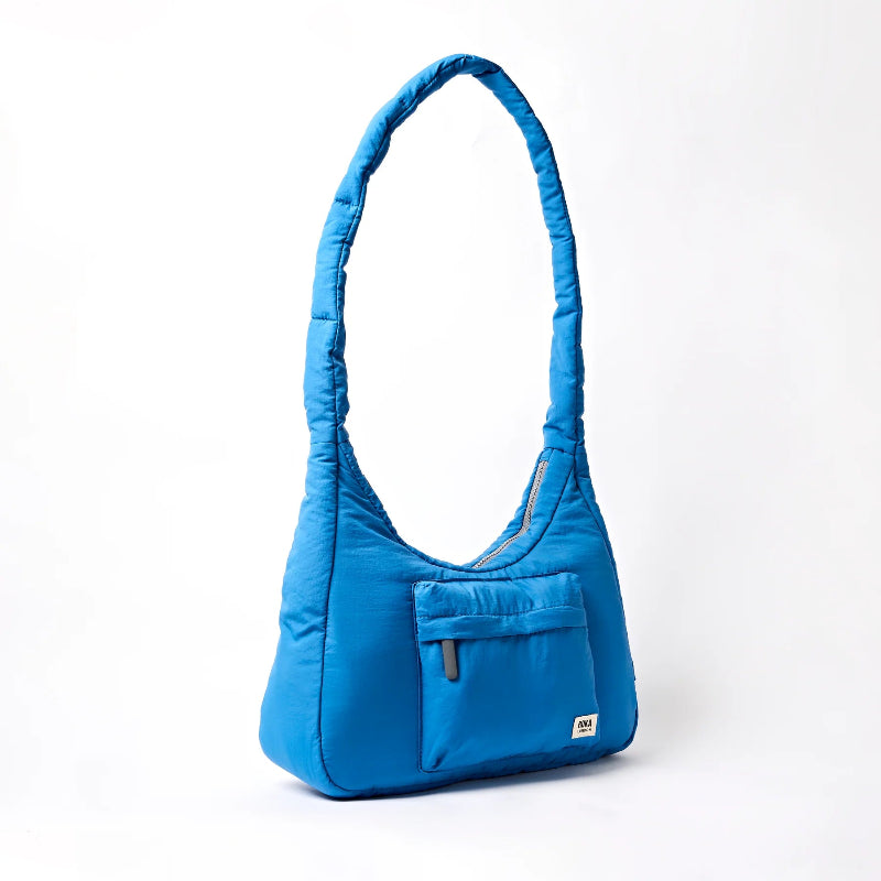 Roka Belize Blue handbag with a pocket on a white background