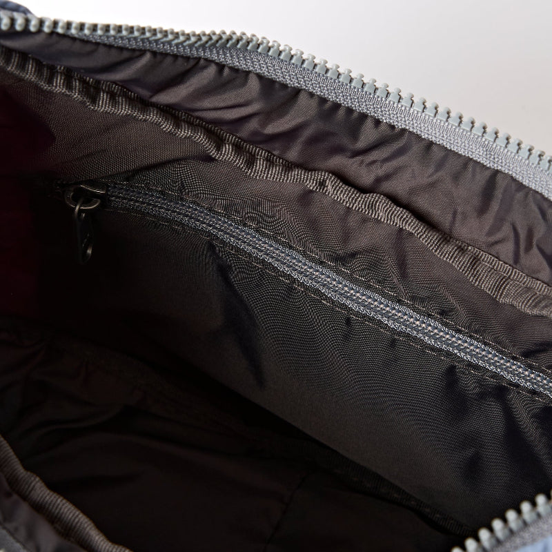 Close-up of a black bag with a zipper, showing texture and material details.