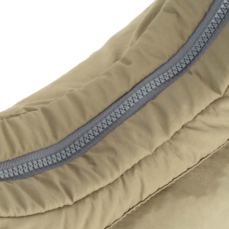 Close-up of a beige sleeping bag with a gray zipper on a white background