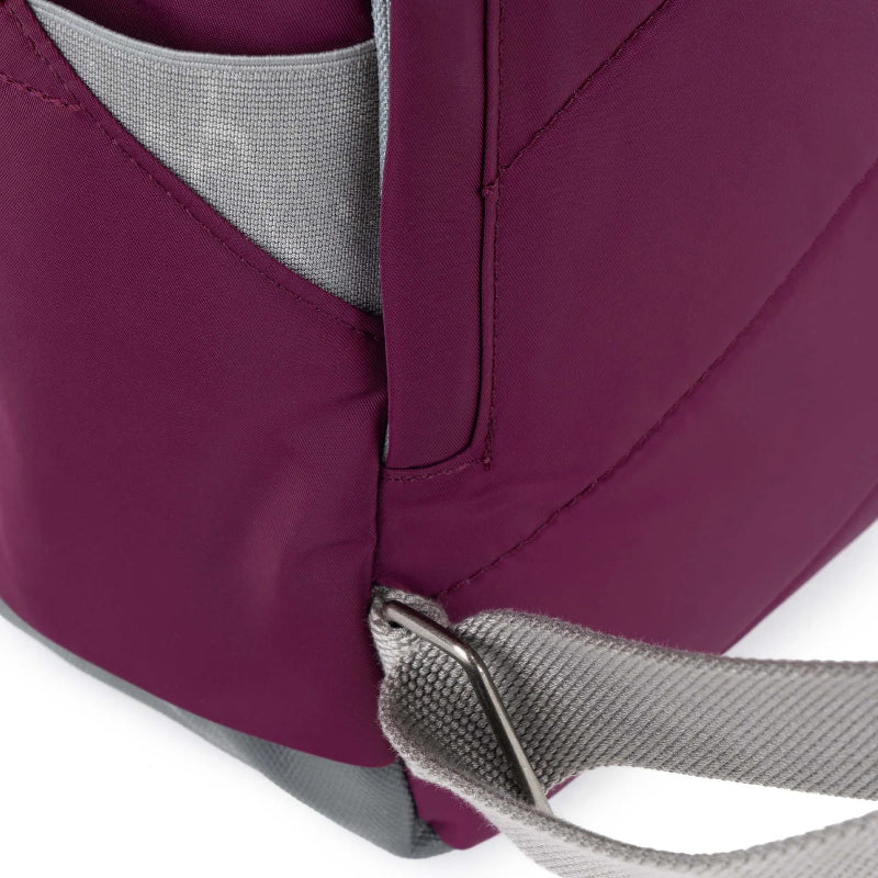 Roka Backpack Canfield Sustainable Medium Royal Burgundy Close-up of a purple backpack with a grey strap on a white background
