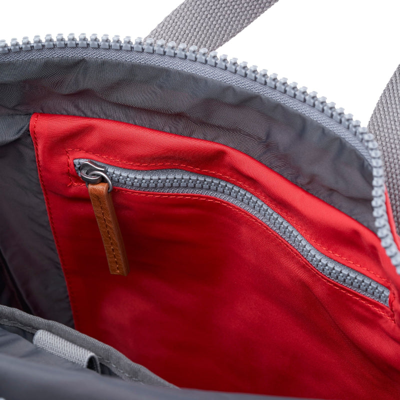 Close-up of a red zipper pocket on a gray bag