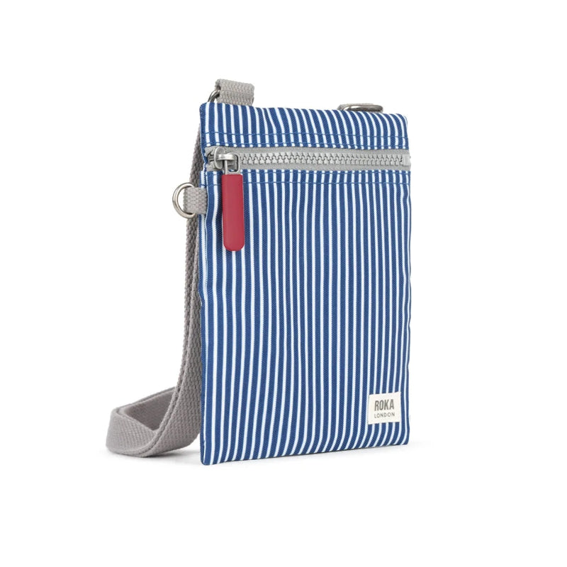 Blue striped crossbody bag with a red tag on a white background